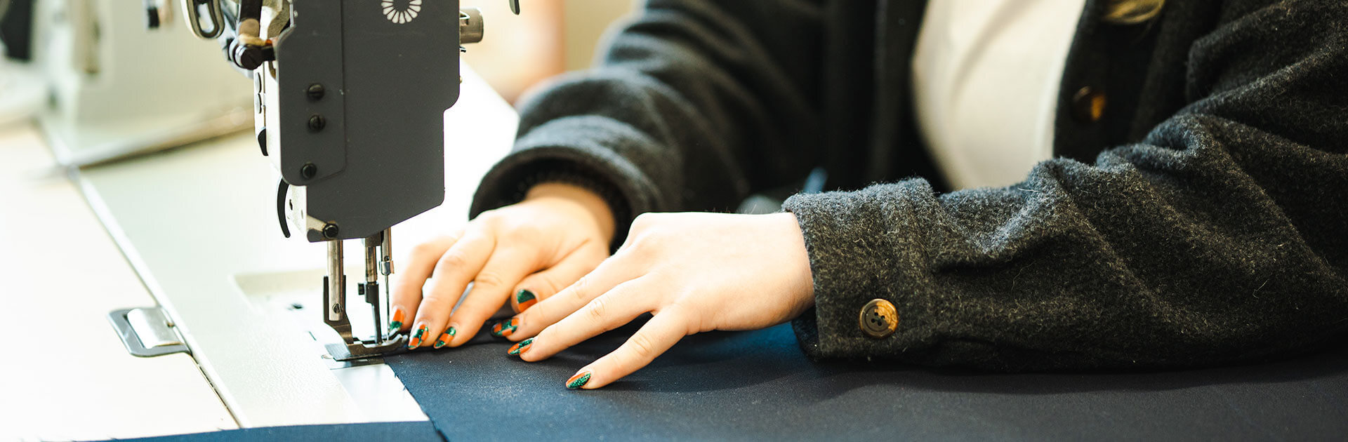 hands sewing canvas